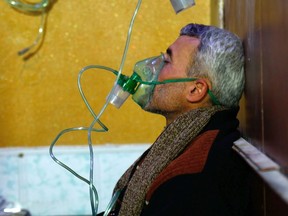 A Syrian man wears an oxygen mask at a make-shift hospital following a reported gas attack on the rebel-held besieged town of Douma in the eastern Ghouta region on the outskirts of the capital Damascus on January 22, 2018. (HASAN MOHAMEDHASAN MOHAMED/AFP/Getty Images)