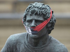The statue of Terry Fox opposite Parliament Hill was adorned with a makeshift face mask. (Postmedia photo)