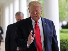 U.S. President Donald Trump talks with a Reuters reporter as they walk down the West Wing colonnade before an interview about China, the novel coronavirus (COVID-19) pandemic and other subjects in the Oval Office of the White House in Washington, D.C.., April 29, 2020.
