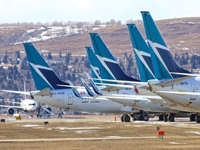 Dozens of WestJet planes are being parked around the Calgary International Airport on March 26, 2020, as the COVID-19 pandemic shuts down most passenger air traffic.