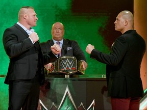 WWE champion Brock Lesnar (left) and former UFC heavyweight champion Cain Velasquez face off as Lesnar's advocate Paul Heyman looks on at T-Mobile Arena on October 11, 2019 in Las Vegas. (Ethan Miller/Getty Images)