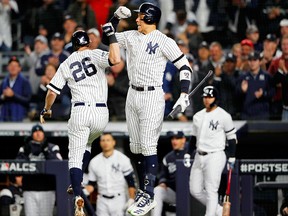 New York Yankees first baseman D.J. LeMahieu (celebrates his home run against the Houston Astros with right fielder Aaron Judge during the first inning of game five of the 2019 ALCS playoff baseball series at Yankee Stadium in New York City on Oct. 18, 2019.