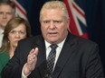 Ontario Premier Doug Ford answers questions as Health Minister Christine Elliott and Finance Minister Rod Phillips listen at Queen's Park in Toronto on Monday, March 23, 2020.