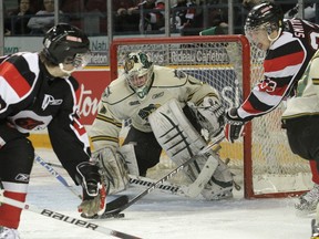 London Knights' goalie Igor Bobkov keeps a close eye on the puck as 67's players #33 Dalton Smith (right) and #19 Tyler Graovac look to make get a shot during second period OHL action in Ottawa on Sunday, February 6, 2010. (Mike Carroccetto, Postmedia News)