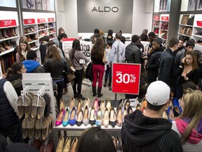 In this Dec. 26, 2012 file photo, shoppers pack an Aldo shoe store looking for Boxing Day bargains at Rideau Centre in Ottawa.
