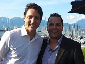 Prime Minister Justin Trudeau, right, poses with Vancouver-East riding chair Mark Elyas in May 2016.