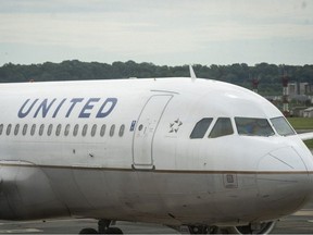 A United Airlines plane sits at a gate Ronald Reagan Washington National Airport, May 5, 2020 in Arlington, Virginia.