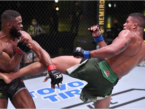 LAS VEGAS, NEVADA - MAY 30: In this handout provided by UFC, (R-L) Gilbert Burns of Brazil kicks Tyron Woodley in their welterweight fight during the UFC Fight Night event at UFC APEX on May 30, 2020 in Las Vegas, Nevada.