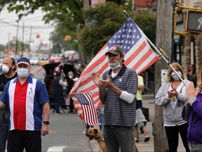 People wear face masks while participating in the annual Memorial Day Parade on May 25, 2020 in the Staten Island borough of New York City.