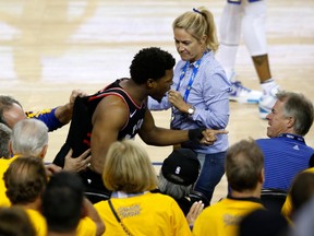 Raptors' Kyle Lowry yells at a fan after being shoved during the NBA Finals last year.