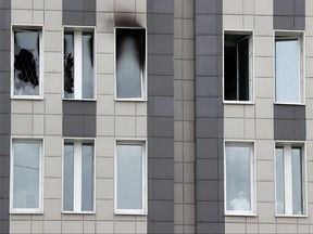 A medical specialist is seen in a window after a fire, which killed five novel coronavirus patients in an intensive care unit, at a hospital in Saint Petersburg, Russia May 12, 2020.