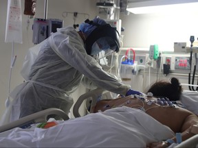 A medical staff member treats a patient suffering from the coronavirus disease (COVID-19) in the Intensive Care Unit (ICU), at Scripps Mercy Hospital in Chula Vista, California, May 12, 2020.
