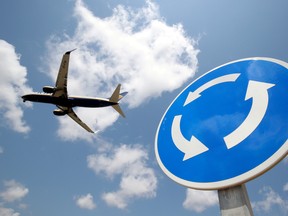 A Ryanair Boeing 737-800 airplane passes a roundabout sign as it lands at Barcelona-El Prat airport, the day before a cabin crew strike is to be held in European countries, in Barcelona, Spain, July 24, 2018.