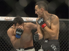 Max Holloway, right, punches Charles Oliveria during the featherweight main event of Ultimate Fighting Championship's UFC Fight Night card at Sasktel Centre on Aug. 23, 2015.
