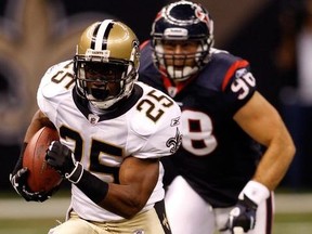 Reggie Bush of the New Orleans Saints runs pas Connor Barwin of the Houston Texans at the Louisiana Superdome on August 21, 2010 in New Orleans, Louisiana.