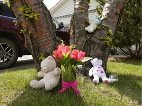 Teddy bears and flowers were left in the front yard of a house at 2504-43 Street in southeast Edmonton on Tuesday May 19, 2020, where Bella Rose Desrosiers died the night before.