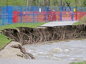 A section of the pathway near Hull's Wood in Fish Creek Provincial Park eroded into Fish Creek when heavy rains of the past few days caused some flooding in the park. Calgarians enjoying clearer skies detoured around the area on Saturday, May 23, 2020.