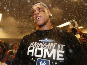 Aaron Judge of the New York Yankees celebrates in the locker room after sweeping the Minnesota Twins in the American League Division Series at Target Field on October 7, 2019 in Minneapolis.