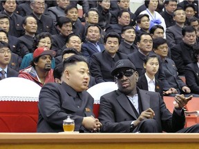 This photo taken on February 28, 2013 and released by North Korea's official Korean Central News Agency (KCNA) on March 1, 2013 shows North Korean leader Kim Jong-Un (front L) and former NBA star Dennis Rodman (front R) speaking at a basketball game in Pyongyang.