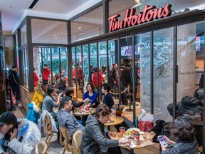 People enjoy food and drink at Canadian coffee-and-donut shop Tim Hortons in Shanghai on Feb. 27, 2019.