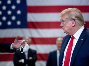 U.S. President Donald Trump tours a Honeywell International Inc. factory producing N95 masks during his first trip since widespread COVID-19 related lockdowns went into effect May 5, 2020, in Phoenix, Arizona.