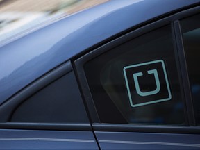 In this file photo taken on July 9, 2019, the Uber logo is seen on a car in Washington, D.C.