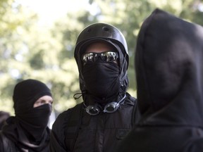 Antifa protesters wear bandanas over their face during a protest to oppose the right wing group "The Patriot Prayer Movement," that was having a rally in Portland, Ore., Sept. 10, 2017.