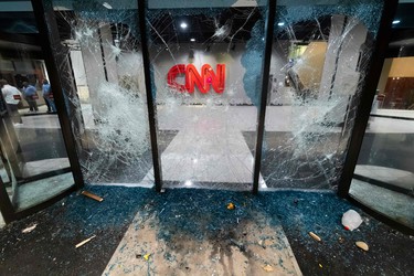A glass wall stands shattered in the aftermath of rioting and protests in Atlanta on May 29, 2020.