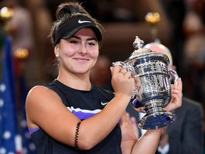 Bianca Andreescu holds the U.S. Open championship trophy after beating Serena Williams at USTA Billie Jean King National Tennis Center in New York City, Sept. 7, 2019.
