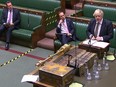 A video grab from footage broadcast by the Parliamentary Recording Unit (PRU) shows Britain's Health Secretary Matt Hancock (C) listening as Britain's Prime Minister Boris Johnson speaks during Prime Minister's Question time (PMQs) in the House of Commons in London on May 6, 2020.