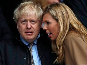In this file photo taken on March 7, 2020 Britain's Prime Minister Boris Johnson and his partner Carrie Symonds attend the Six Nations rugby match between England and Wales at the Twickenham.