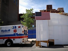 An ambulance is seen backed up to a temporary morgue outside Wyckoff Heights Medical Center in the Brooklyn borough of New York City, during the outbreak of COVID-19, on Wednesday, May 27, 2020.