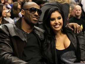 In this Feb. 13, 2010, file photo, Kobe Bryant of the Los Angeles Lakers smiles with his wife Vanessa Lynne during the Taco Bell Skills Challenge on All-Star Saturday Night, part of 2010 NBA All-Star Weekend at American Airlines Center in Dallas, Texas.