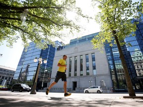 A jogger runs past the Bank of Canada building in Ottawa, Ontario, Canada, July 11, 2018.