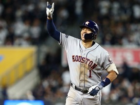 Carlos Correa of the Houston Astros celebrates his three-run home run against the New York Yankees at Yankee Stadium on October 17, 2019 in New York.