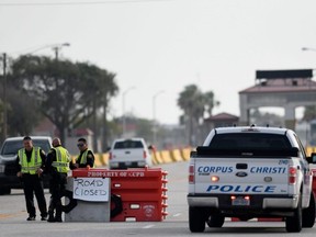 Police officers stand at a checkpoint after a shooting incident at Naval Air Station Corpus Christi, Texas, May 21, 2020.
