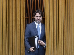 Prime Minister Justin Trudeau walks through the curtains before a session of the Special Committee on the COVID-19 Pandemic to begin in the Chamber of the House of Commons in Ottawa, Wednesday May 13, 2020.