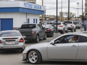 People line up to get food from Peters' Drive-In in Edmonton on Monday, May 11, 2020.