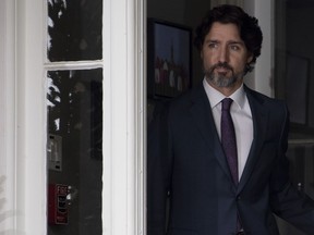 Prime Minister Justin Trudeau looks towards the podium as he walks out the front door of Rideau Cottage to attend a news conference in Ottawa, Monday, May 25, 2020.