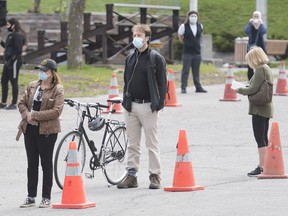 People wait to be tested for COVID-19 at a mobile clinic in Montreal, Sunday, May 17, 2020, as the COVID-19 pandemic continues in Canada and around the world.