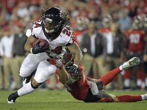 Atlanta Falcons running back Devonta Freeman (24) looks to get around Tampa Bay Buccaneers free safety Chris Conte, right, Monday, Dec. 18, 2017, in Tampa, Fla.