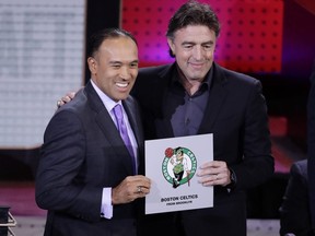 NBA Deputy Commissioner Mark Tatum, left, poses for photographs with Boston Celtics co-owner Wyc Grousbeck, right, after the Celtics won the first pick in the NBA draft Tuesday, May 16, 2017, in New York.