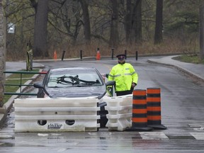 Police stand guard at Toronto's High Park to prevent further spread of COVID-19 amongst the public.
