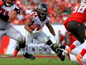 In this December 29, 2019, file photo, Devonta Freeman of the Atlanta Falcons rushes during a game against the Tampa Bay Buccaneers at Raymond James Stadium in Tampa, Fla.