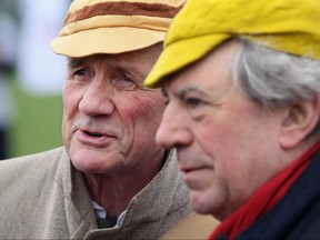 Former 'Monty Python' actors Michael Palin, left, and Terry Jones attend a 'Hopathon' world record attempt on Hampstead Heath athletics track on March 3, 2012 in London.