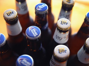 In this photo illustration, bottles of Miller Lite and Bud Light beer that are products of SABMiller and Anheuser-Busch InBev (respectively) are shown on Sept. 15, 2014 in Chicago. Illinois.