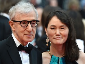 Director Woody Allen and his wife Soon-Yi Previn pose as they arrive on May 11, 2016 for the screening of the film "Cafe Society" during the opening ceremony of the 69th Cannes Film Festival in Cannes, southern France.