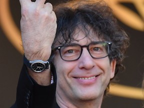 British novelist Neil Gaiman gestures as he arrives on May 21, 2017 for the screening of the film 'How to talk to Girls at Parties' at the 70th edition of the Cannes Film Festival in Cannes, southern France.