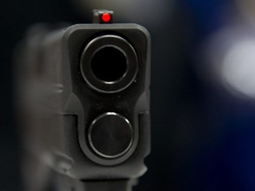 This file photo taken on April 25, 2014 shows a view down the barrel of a semi-automatic handgun.