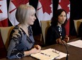 Federal Minister of Health Patty Hajdu, left, listens as Chief Public Health Officer of Canada Dr. Theresa Tam participates in a press conference following the Ontario Government's announcement of the first presumptive confirmed case of a novel coronavirus in Canada on Sunday, Jan. 26, 2020